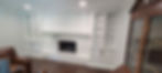 Custom cabinets with bookshelves and fireplace surround