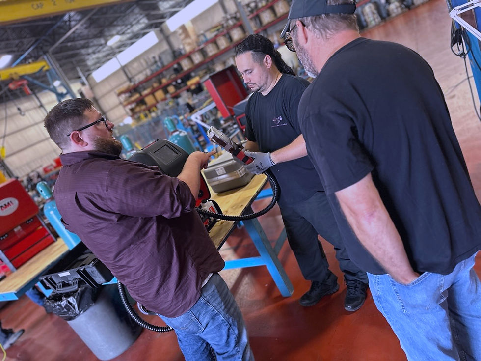 OWETEC instructor demonstrating orbital welding equipment to trainees in a workshop setting in Ohio, providing hands-on weldi