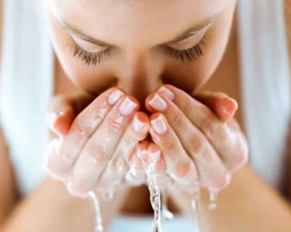 Woman washing her face
