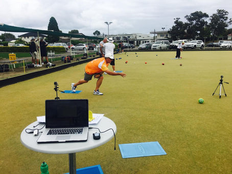 lawn bowls coach reviewing player delivery during personalised coaching lesson
