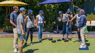 new lawn bowlers preparing to deliver a bowl during practice