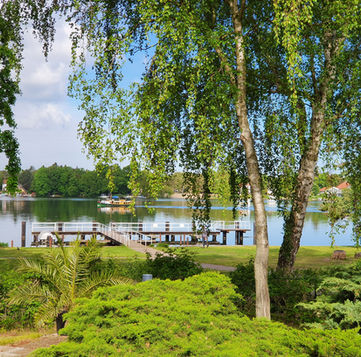 Seeterrassenblick mit Kahn Events, Feiern, Bankett, Seminar & Konferenzen im Waldhotel am See Berlin bei Brandenburg, Köpenick Hotel, Köpenick Eventlocation, Köpenick Seminare, Retreat am See, Retreat im Wald, Auszeit am See, Auszeit in Berlin, Auszeit im Wald, Ufer Dahme, Auszeit im Grünen, Seeterrasse mit Sonnenuntergang am Ufer, Ausflug in Berlin, Ausflugsziel am Stadtrand, Ausflug ins Grüne