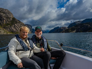 Private fjord tour in Lysefjord near Stavanger, Norway with guests enjoying calm waters and mountain scenery