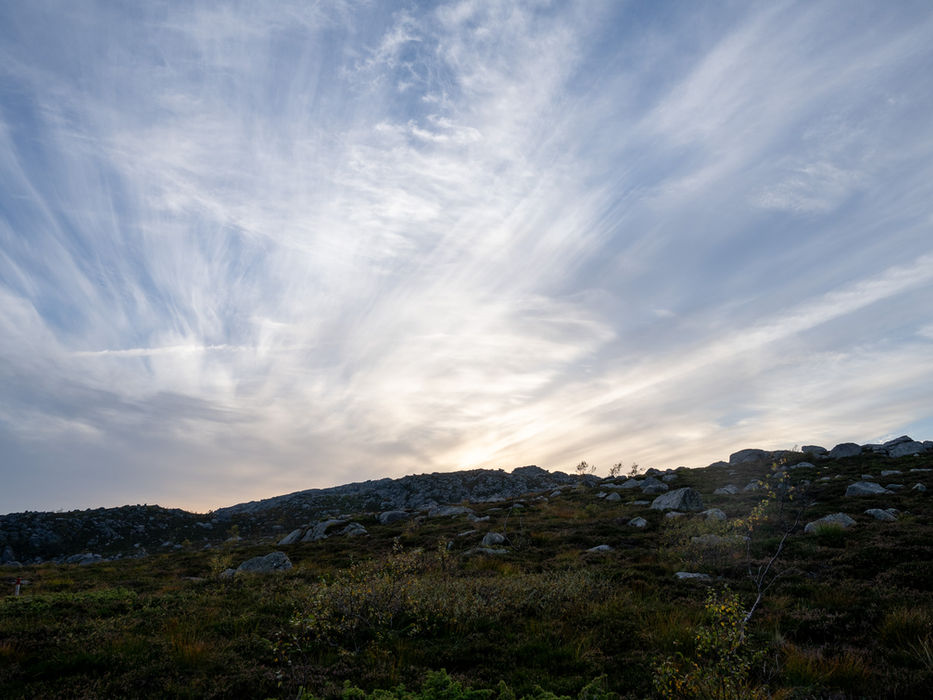 Dramatic evening sky above Reinaknuten mountain terrain