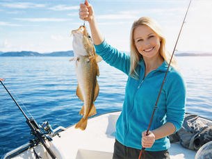 woman holding cod on boat fjord fishing stavanger vs bergen norway