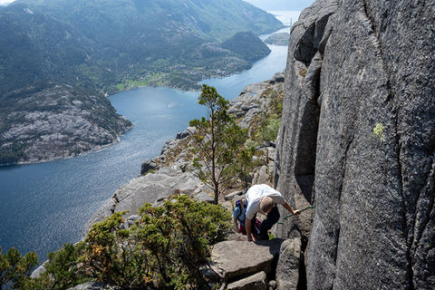 Hiker navigating a narrow rock section on the optional adventurous route during the guided hike to The Hat