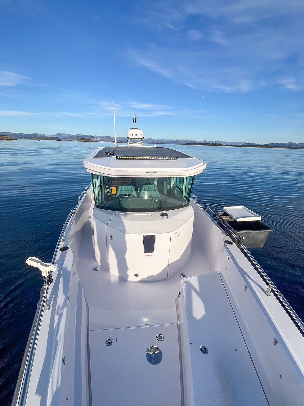 Private fjord fishing boat in Stavanger Norway on calm water with clear conditions