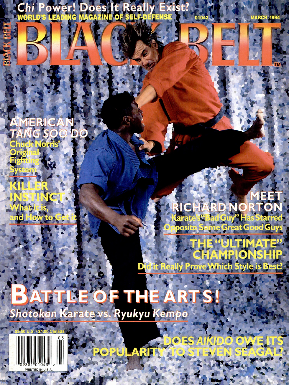 Two martial artists sparring, one in blue and one in orange, against a textured backdrop. The magazine cover features bold text: Black Belt.