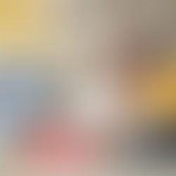 Two women whispering in an office, one wearing a yellow sweater. A computer screen displays a spreadsheet. Bright, cozy atmosphere.