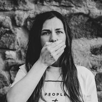 mulher cobrando a boca com a mão