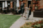 A Dorset Wedding Coordinator moving a pallet timeline at Orangery Suite Wimborne - PeterWelland Photography.JPG