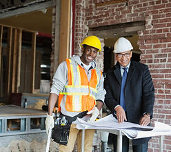 Construction worker and engineer with permit and blueprints