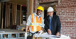 Construction Worker and Building Owner Collaborating