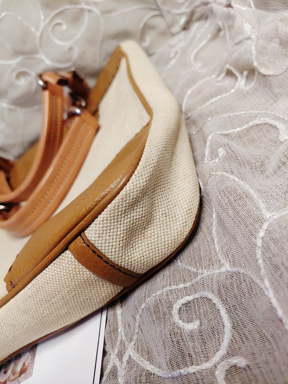 Thumbnail: Close-up of cream woven canvas and cognac leather corner construction on vintage Prada tote.