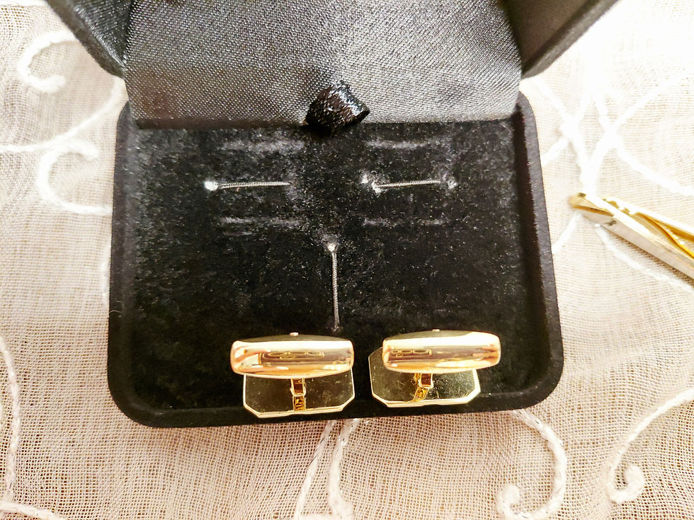 Thumbnail: Pair of YSL cufflinks showing geometric gold-tone faces and black accent detail