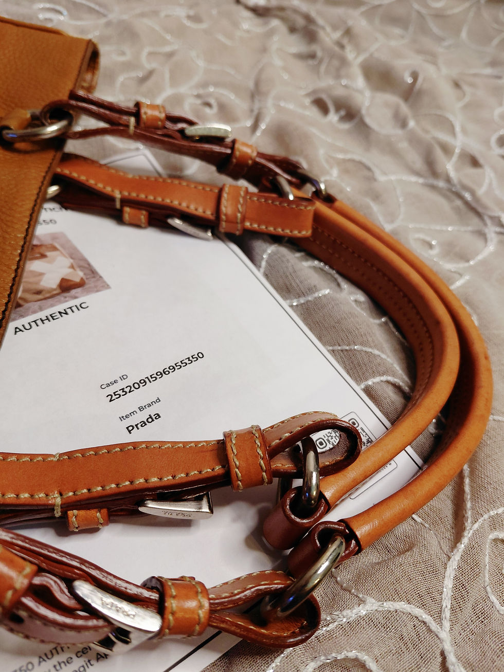 Thumbnail: Cognac leather Prada tote handles with adjustable buckles, contrast stitching and silver-tone hardware.
