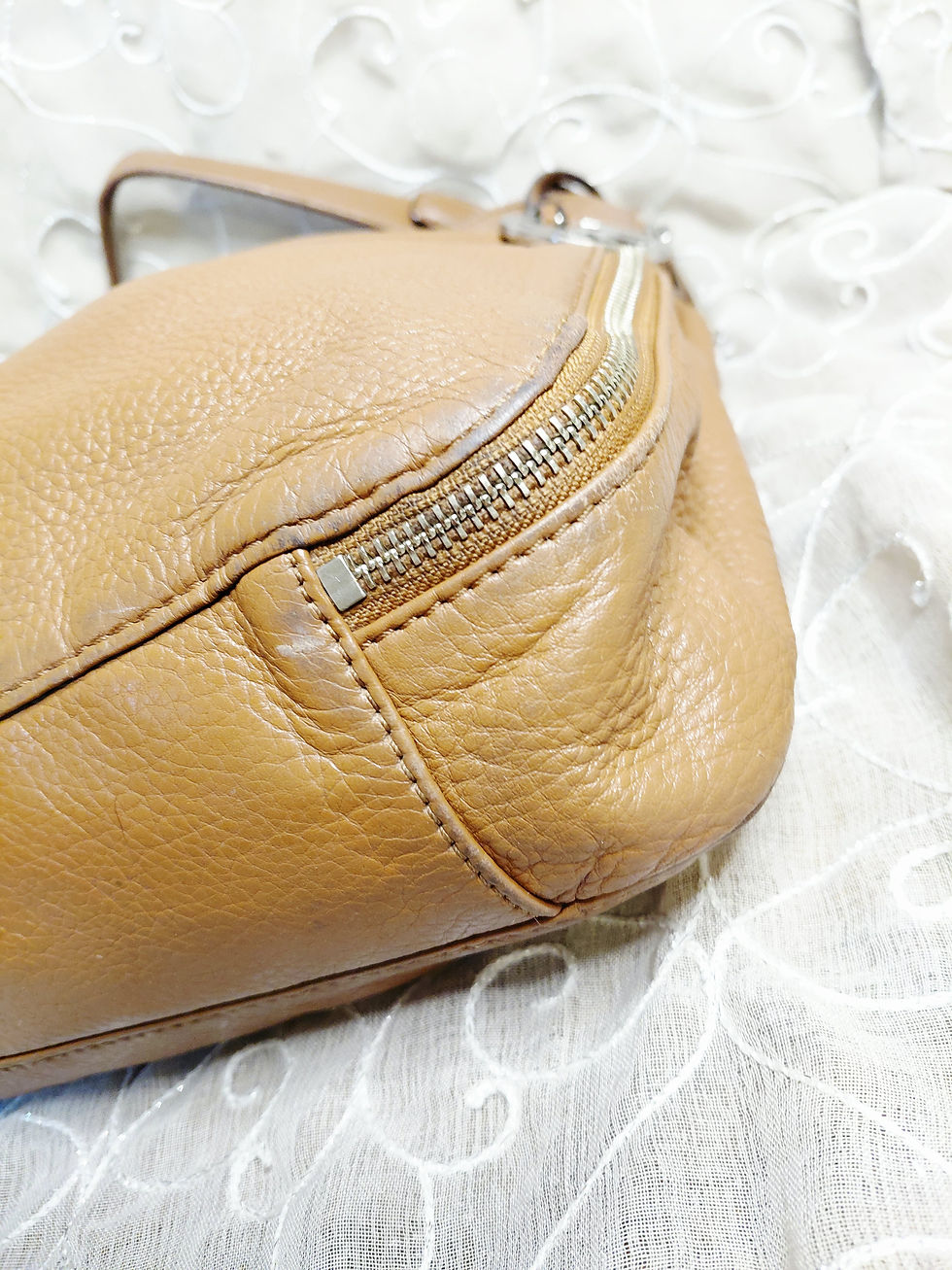Thumbnail: Close-up of opposite bottom corner and piping showing normal wear.