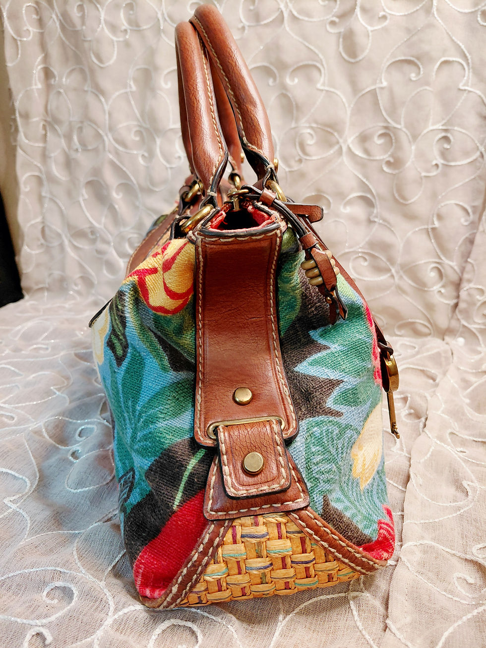 Thumbnail: Side profile of vintage Fossil floral satchel showing leather straps, metal hardware and woven construction.