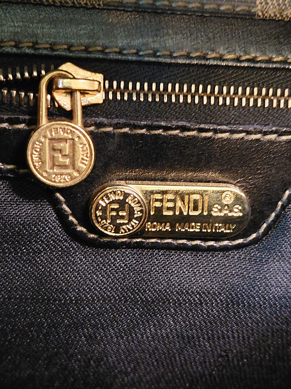 Thumbnail: Close-up of vintage Fendi gold-tone FF zipper pull and Fendi S.A.S. Roma Made in Italy plaque.
