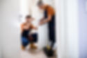 Full length shot of two locksmith, repairmen, workers in uniform installing, working with