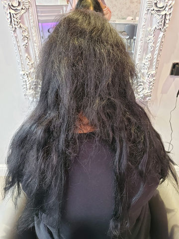 a person's back with tangled hair