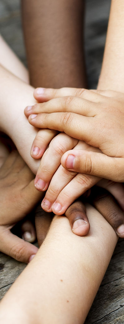 Diverse hands are join together on the w