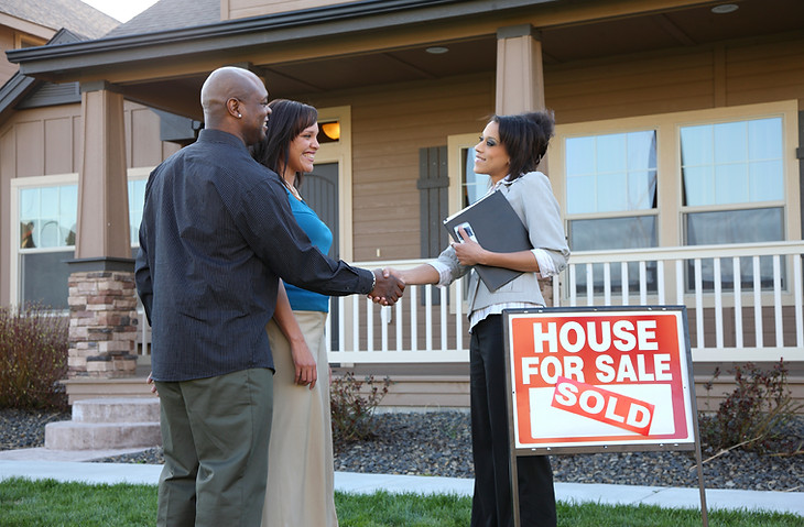 couple-shakes-hands-with-realtor-house-sold.jpg