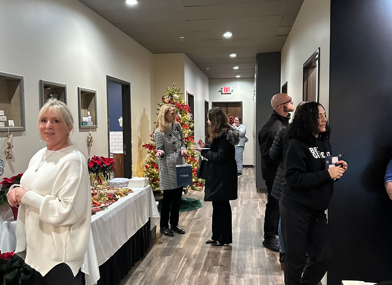 Guests celebrating at the Evergreen Plastic Surgery open house, enjoying Christmas themed decorations and learning about skin care, botox, filler, facelift, neck lifts, breast surgery, mommy makeovers, and eyelid surgery!