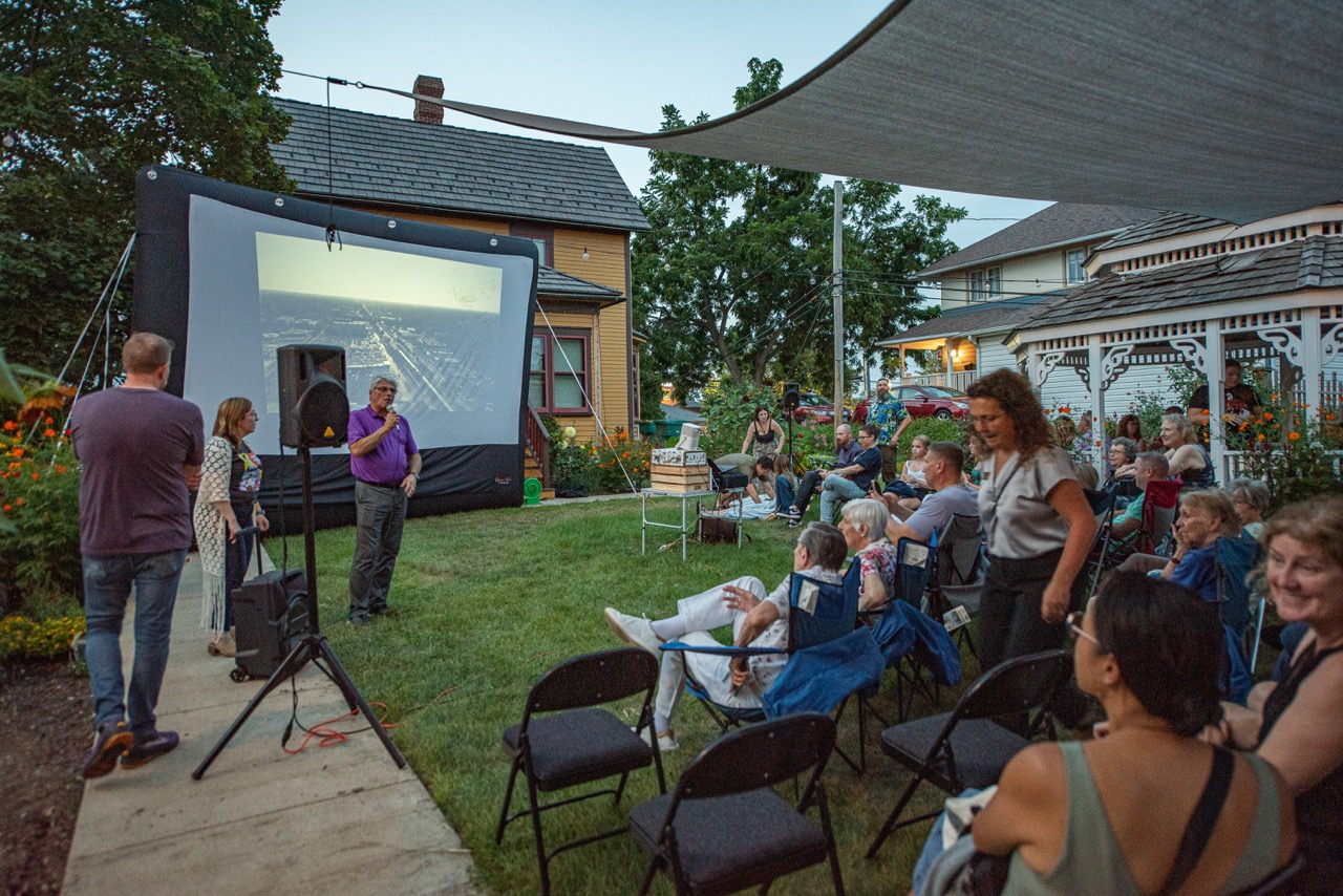 Residents gathering for an outdoor community screening