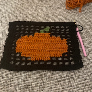 Finished project of a pumpkin using fillet crochet