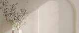 A background of a potted tree in front of a light beige colored wall
