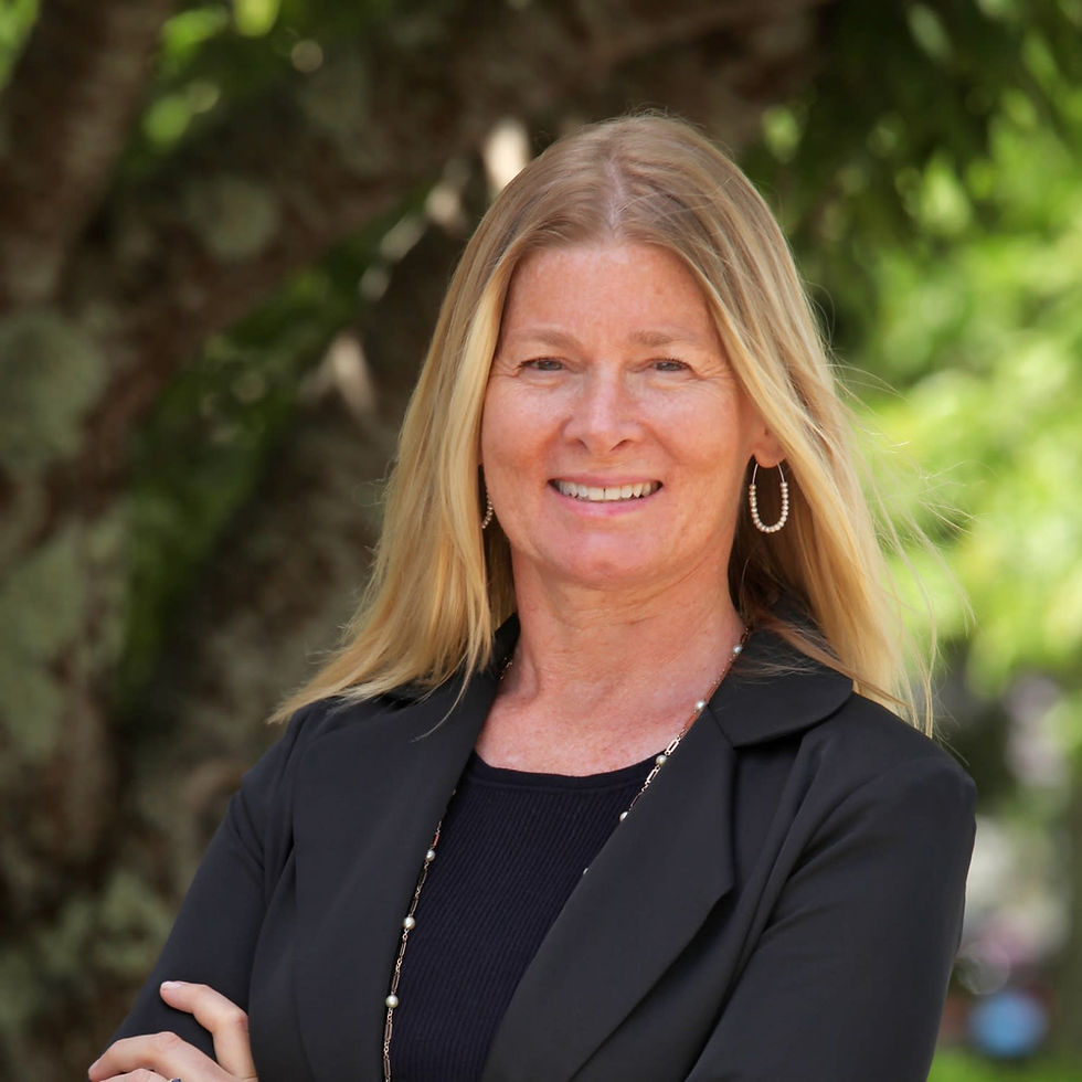 Kerrie Marzot smiling outside wearing a black blazer