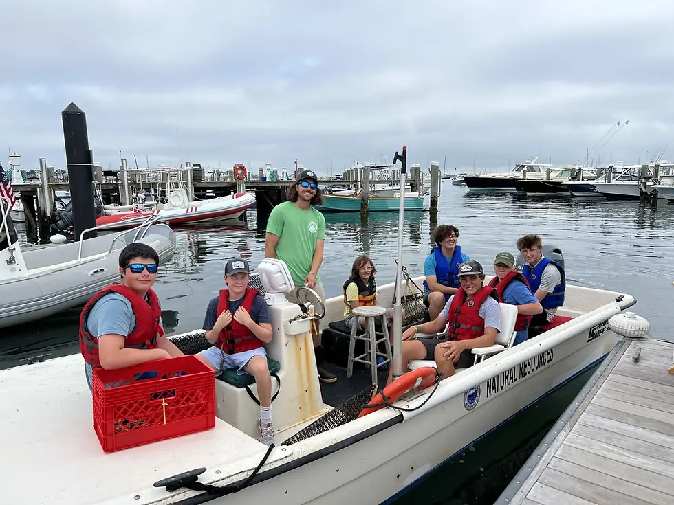 Kids in the Youth Harbor Education Program sitting on a docked boat
