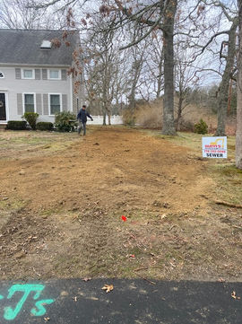 Cleared dirt path for landscaping project beside a house