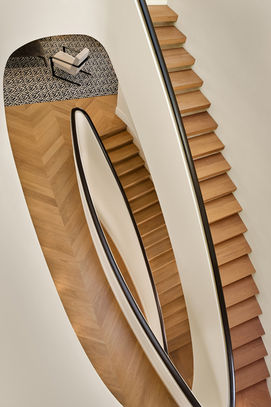 Dramatic elliptical staircase in historic residence