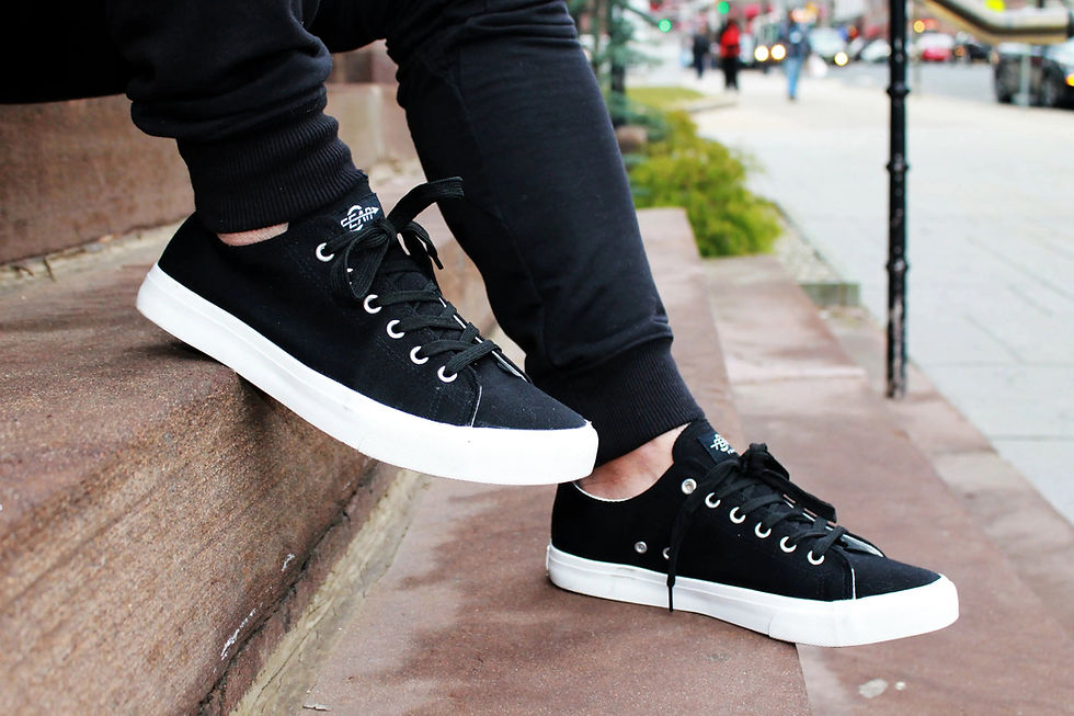 Black canvas sneakers with white soles