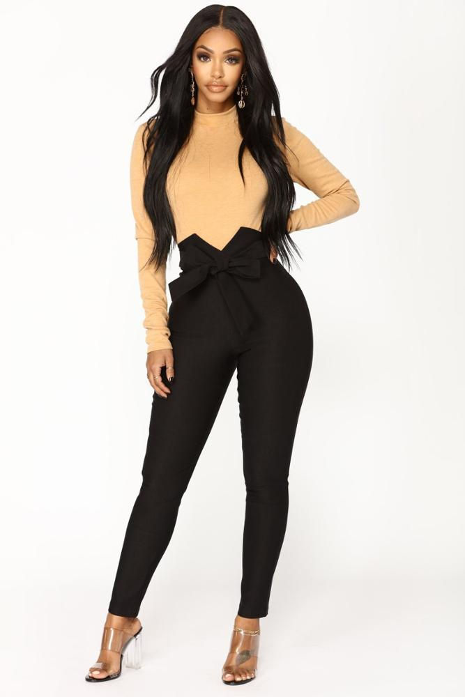 Thumbnail: Woman in beige top and black high-waisted pants