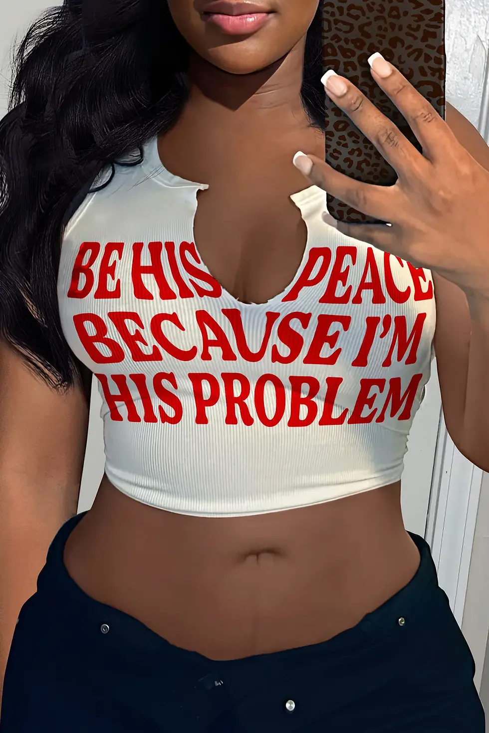 Thumbnail: Woman's white crop top with red text: "Be his peace because I'm his problem"