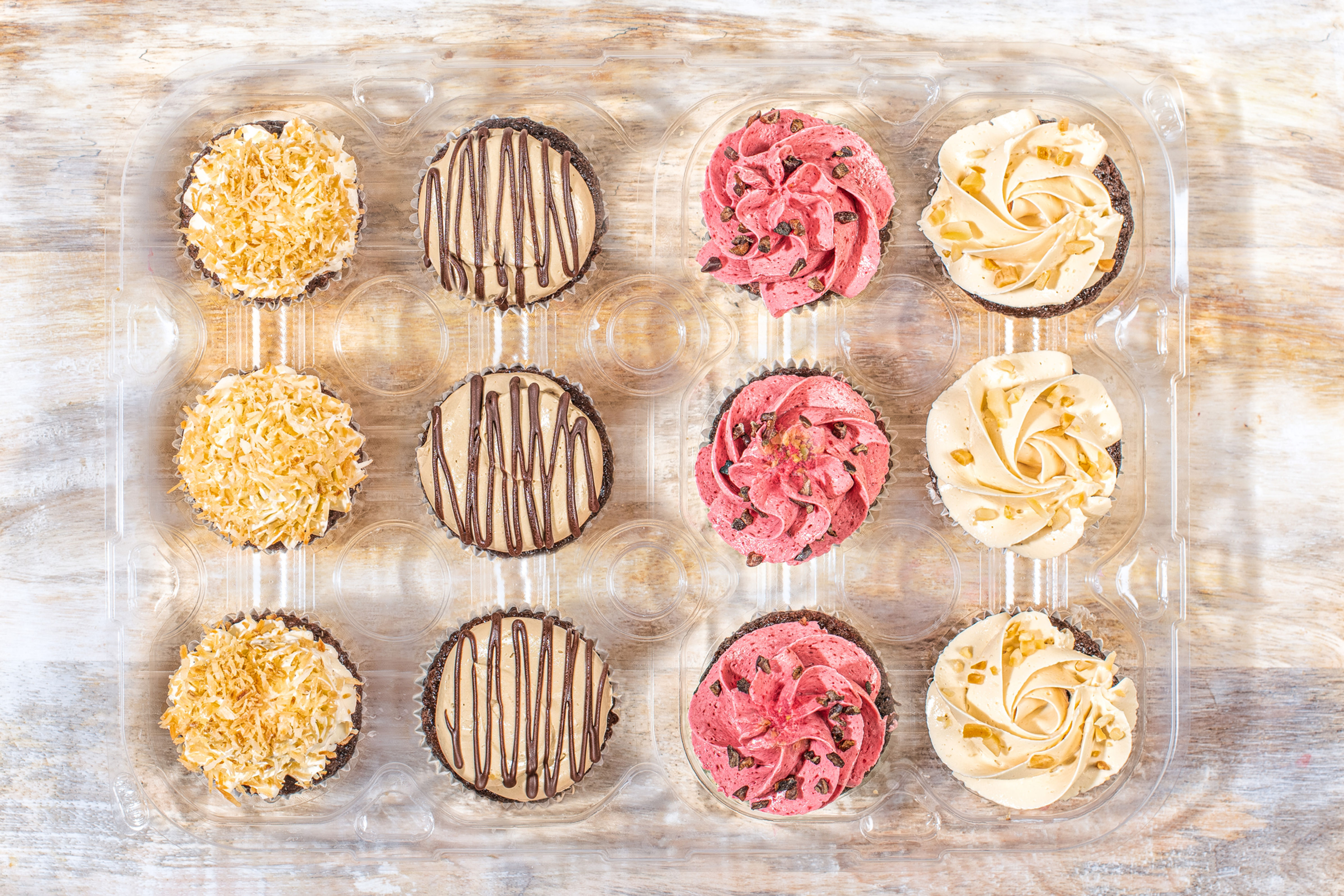 Assorted cupcakes in box: variety of flavors