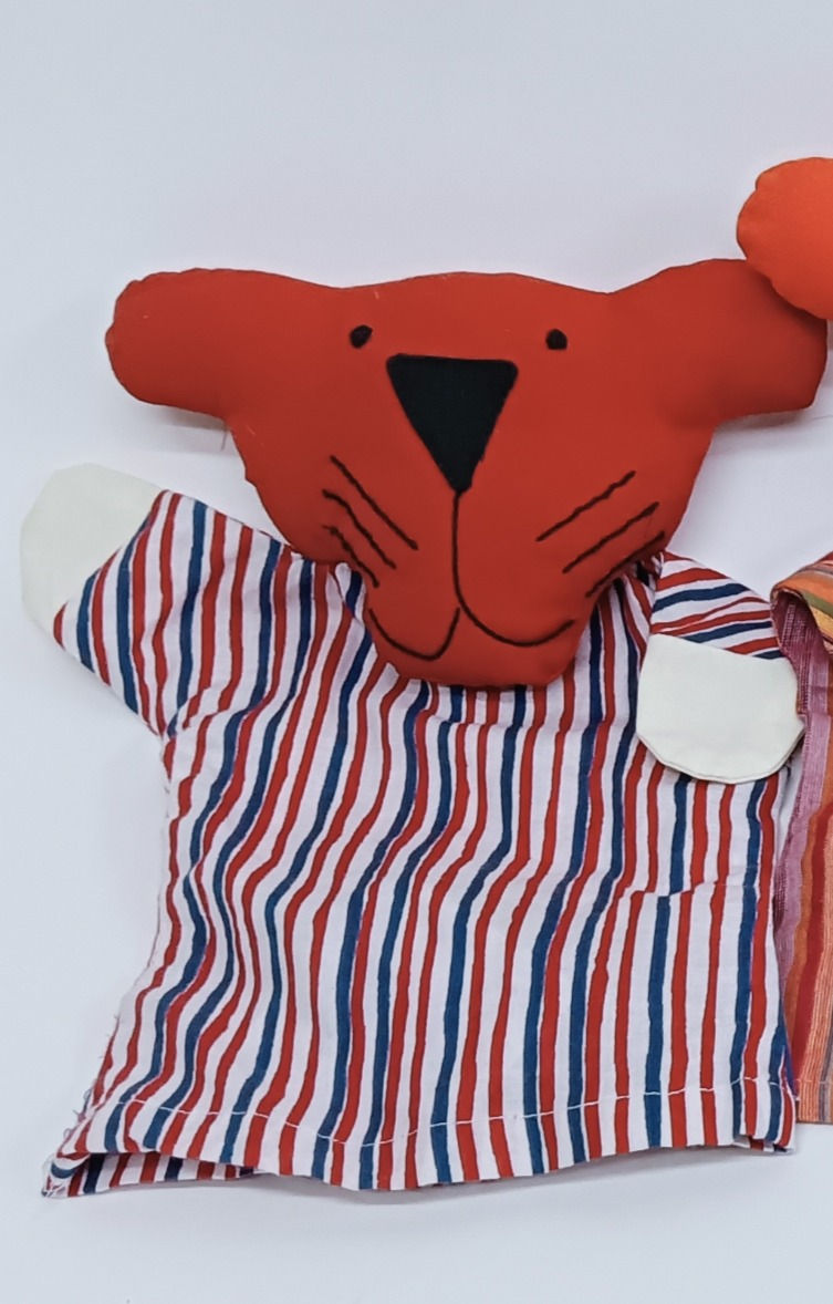 Thumbnail: Tiger puppet with a red head and striped body, being used