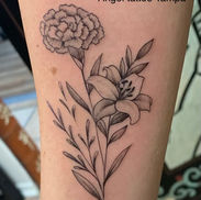 example of a birth flowers creation tattoo bouquet in black and grey by angel tattoo Tampa shop owner Laetitia Coleman