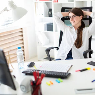 medical assistant relaxed in a chair in front of a desk
