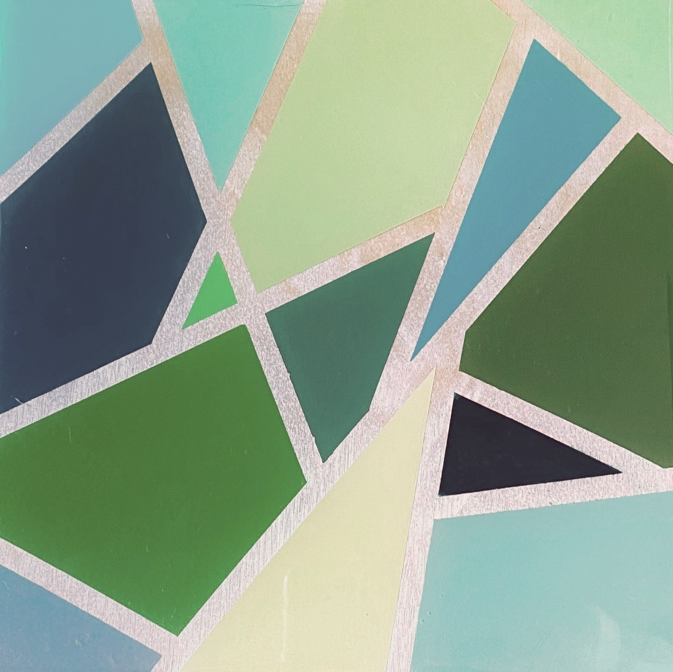 square green geometric shapes on a wood panel