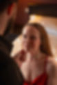 Brunette lady down lower than a man dressed in black his hand is on her chin and her eyes are looking up at him longing for more