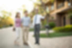 Real estate agent showing a new home to a young couple.
