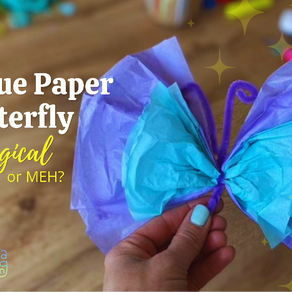 Tissue paper butterfly craft made from purple and blue tissue paper with a purple chenille stem, held in a hand on a wooden table with the text “Tissue Paper Butterfly: Magical or Meh?” displayed on the image.