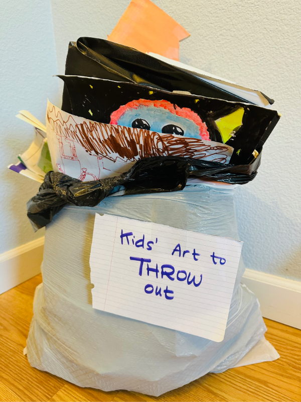A photo of kids' artwork that has been thrown out. You can't hold onto it forever!