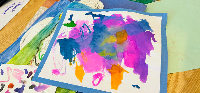 A pile of kids' artwork that needs to be organized!