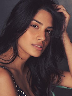 Daniela M - headshot of a female model with long hair, a natural expression, and wearing a black vest top, represented by ROC Talent Agency UK