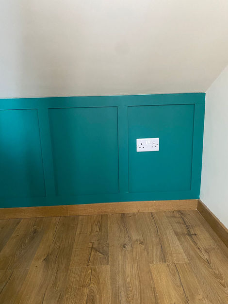 Details that make a difference
This teal wall panelling not only adds style but also provides a practical finish, seamlessly integrating with sockets and the natural wood flooring. A bold and modern touch for any bedroom or living space.